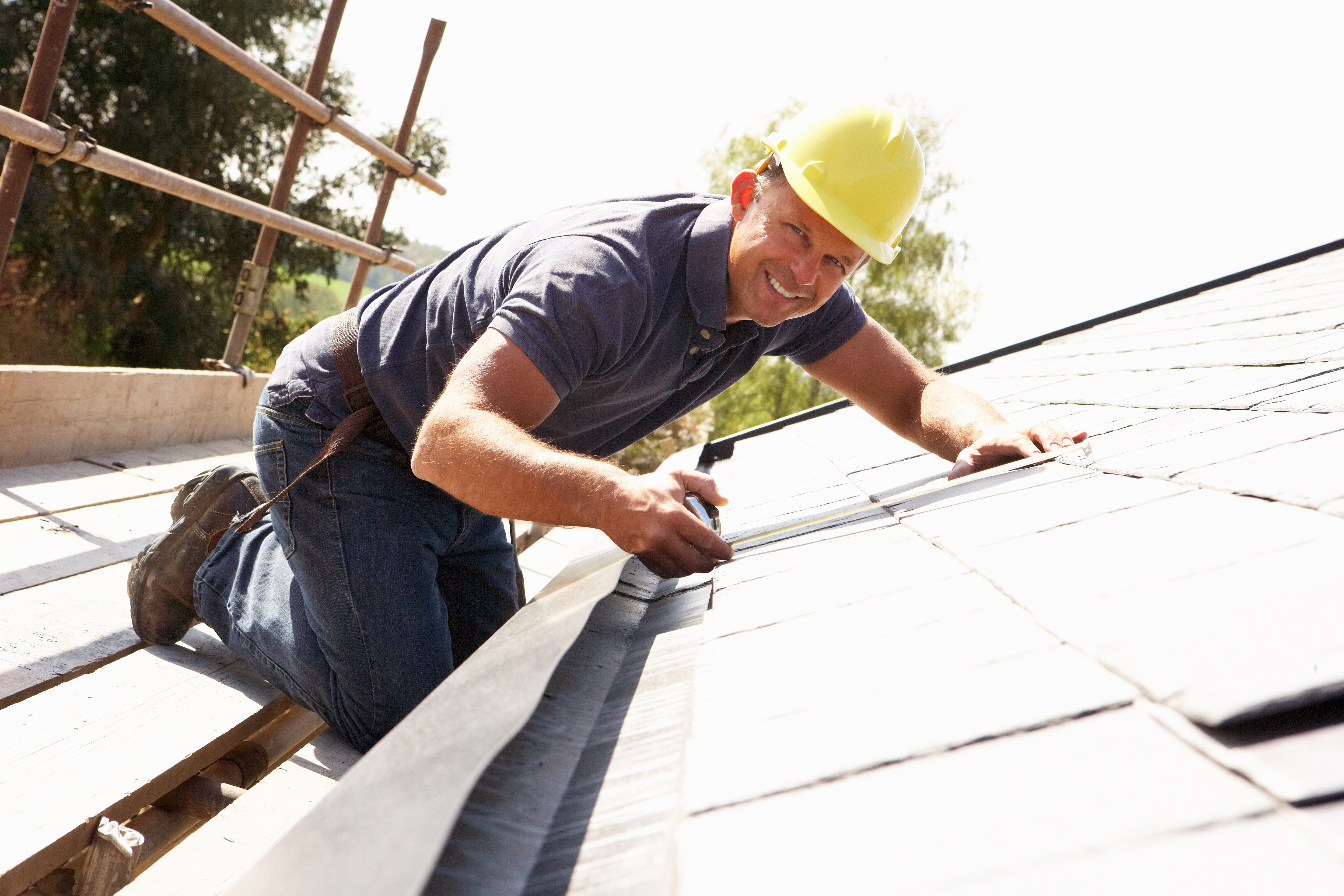 Roofer Working On Exterior Of New Home